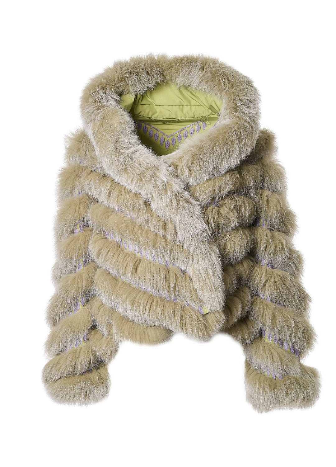 Woman in a green fur coat and purple skirt standing on steps in an urban setting