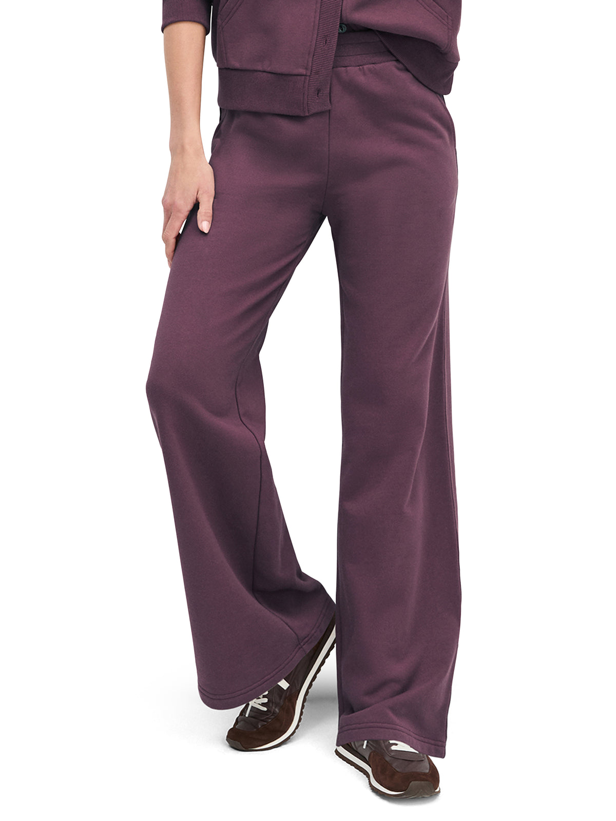 Purple pants worn by a person on a white background